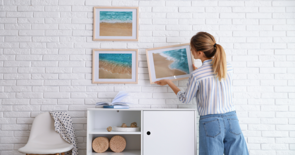 woman hanging pictures
