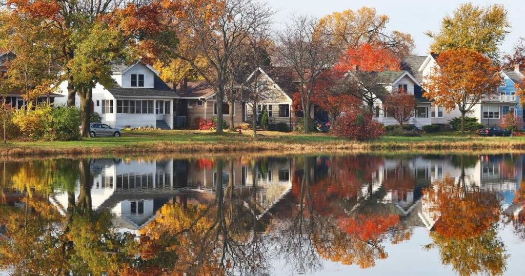 houses on a pond with fall leaves